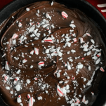 Top shot of chocolate melted in a skillet with peppermint candy pieces