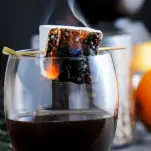 Cocktail in glass with marshmallow on fire