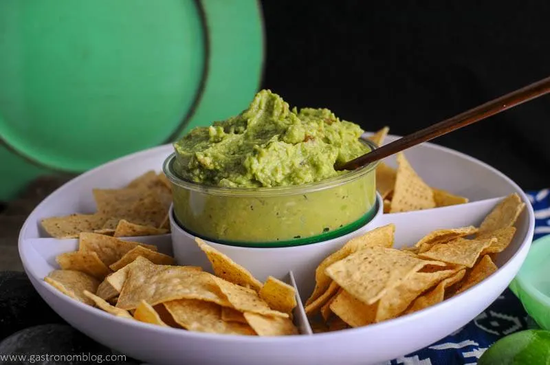 Guacamole and chips in a white bowl