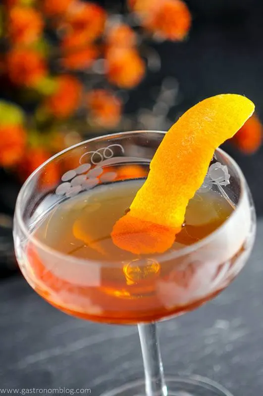 The Woodsman - An Apple Brandy and Ginger Cocktail in a coupe, orange peel