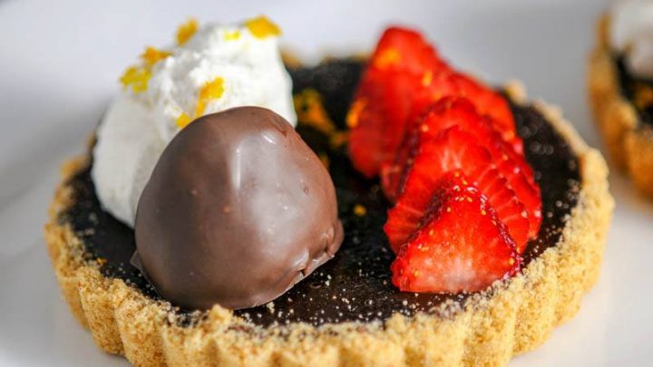 Chocolate Bourbon Tart with Strawberries on white plate