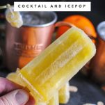 Sunrise Moscow Mule and Popsicles, hand holding popsicle. Copper mug with candied ginger and orange in background