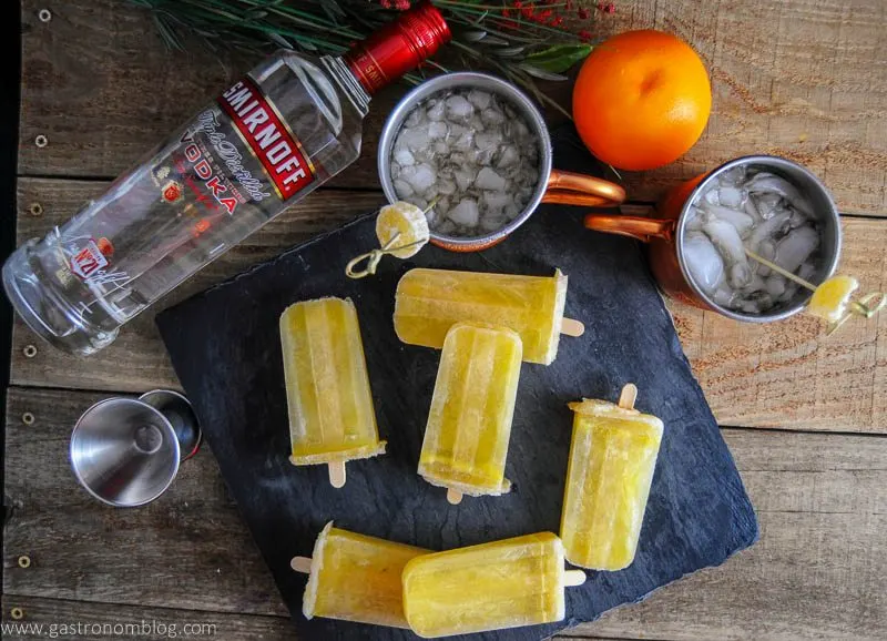 Sunrise Over Moscow Mule Ice Pops and Moscow Mule cups, orange and vodka bottle