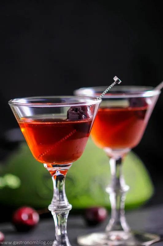The Cherry Blossom Cocktail in two cocktail coupes with cherries and cocktail picks