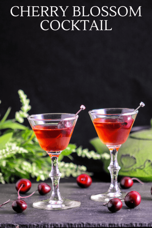 Red cocktails in small glasses with cherries