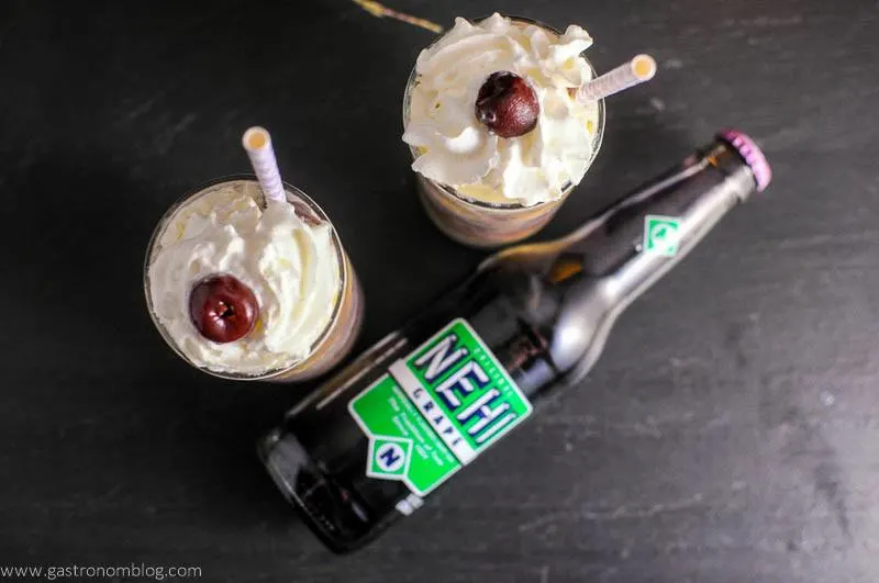 Adult Purple Cow with Nehi Grape Soda top shot with whipped cream and cherries with straws. Nehi Grape soda bottle