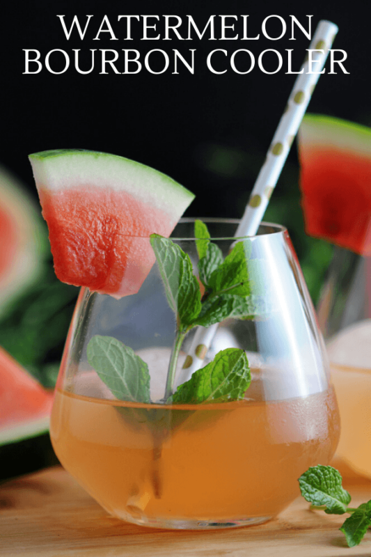Pink cocktail in glass with mint, watermelon slice and straw