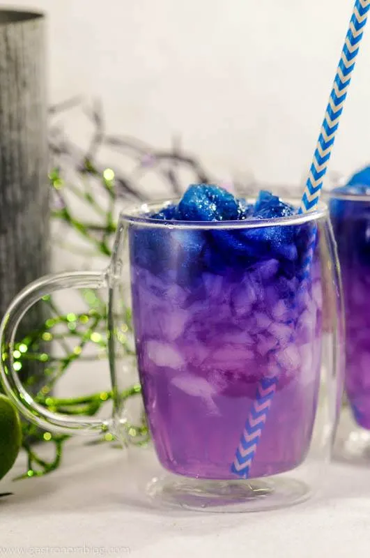 Galaxy Magic Moscow Mule in clear glass mug with blue straw. Color changing cocktail