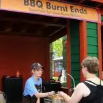 KC Flavor Fest, Leah getting plate of bbq from woman at Worlds of Fun