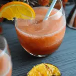 Orange ocktail in glass with orange slices