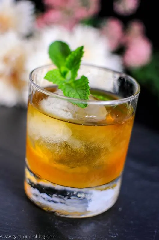 Apricot Honey Bourbon Sour Cocktail in rocks glass with mint leaves