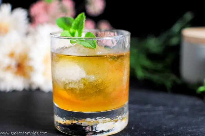 Apricot Honey Bourbon Sour Cocktail in rocks glass with mint leaves