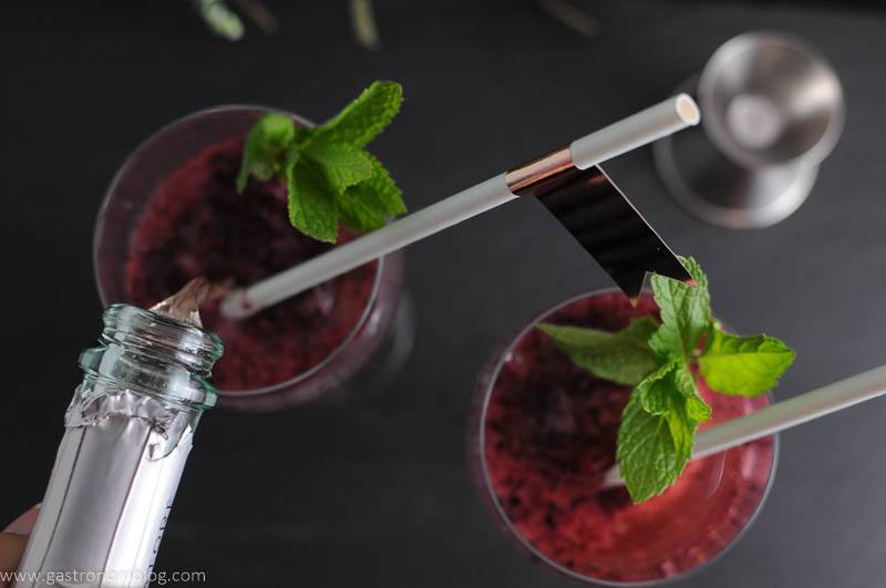 Blueberry Mint Sorbet Rose Float top shot with rose being poured in, with straws and mint