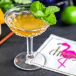 Orange cocktail with mint, flamingo napkin