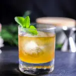 Gold cocktail in rocks glass with mint