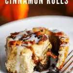 Cinnamon roll on white plate with fork