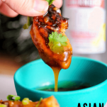 Chicken wing dipped in sauce in green bowl