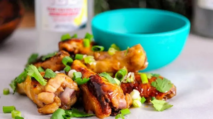 Asian chicken wings glazed in a sauce made from Smirnoff Ice, Brown Sugar, and teriyaki are a great holiday party appetizer!