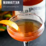 Earl Grey Manhattan, brown cocktail in coupe with orange peel. Whiskey bottle behind