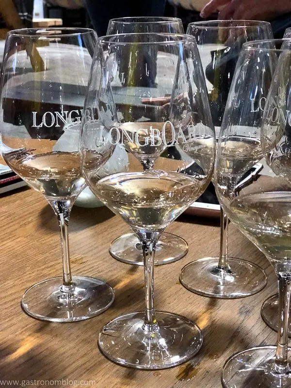 cluster of Longboard winery glasses filled with white wine