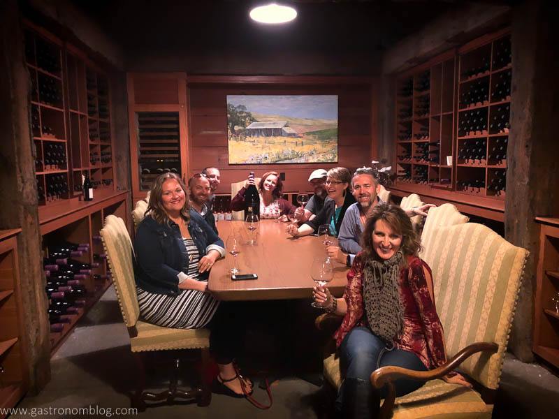 Our group of friends in the members exclusive tasting room in the wine cave of Thomas George Estates - 8 of us around a table in the cave tasting room Winery.