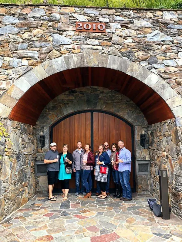 The Caves at Thomas George Estates Winery, 8 people standing in front of doors