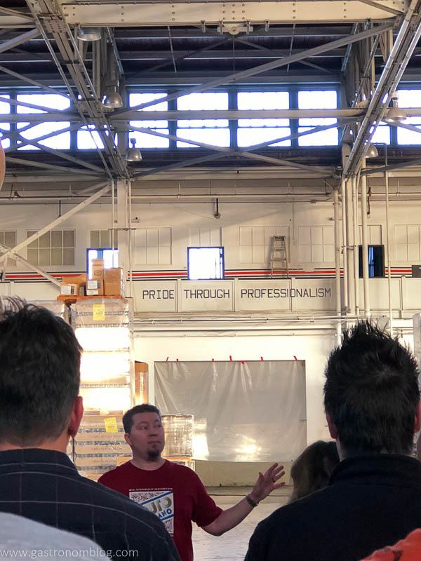 tour guide takes folks thru the old aircraft hanger that now serves as the St George Spirits Distillery