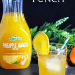 Yellow cocktail with orange slice and straw, Bottle of pineapple juice