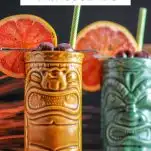 Rambler's Ruby Tiki Cocktail in brown and teal tiki mugs with grapefruit wheels and straws