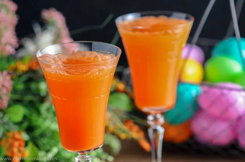 Two Carrot Ginger Mimosas in Rolf Glass Gatsby Cocktail Flutes and spring flowers and easter eggs