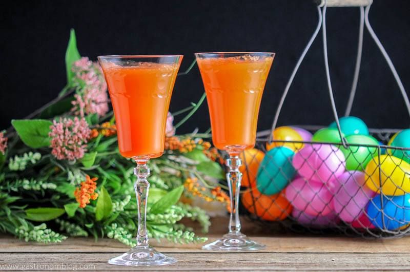 Two Carrot Ginger Mimosas in Rolf Glass Gatsby Cocktail Flutes and spring flowers and easter eggs