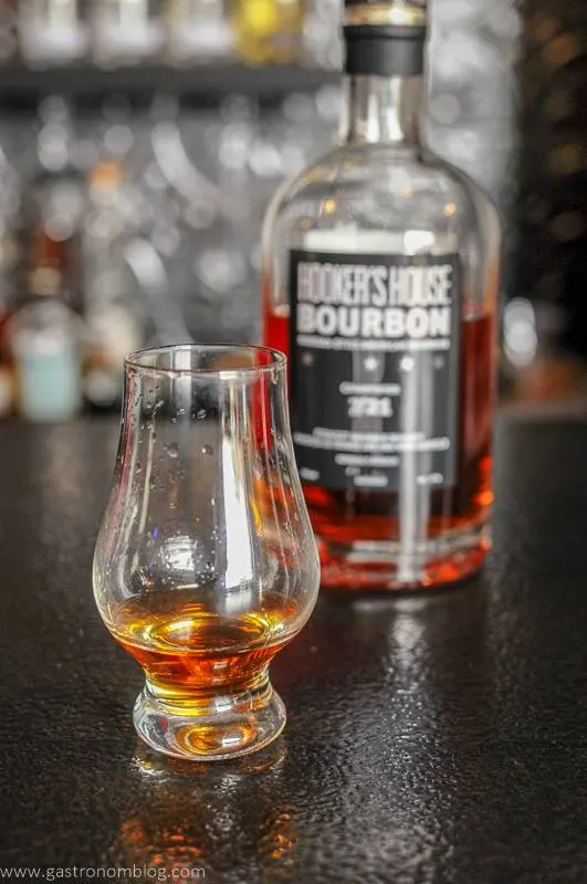 A bottle of Prohibition Spirits Hooker's House Bourbon and a sampling glass
