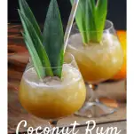 Cocktails in glasses with pineapple fronds