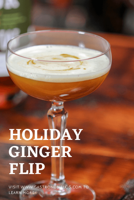 Holiday Ginger Flip Cocktail in a coupe on wood surface