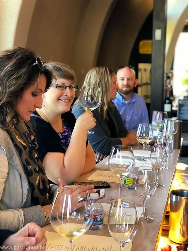 Friends enjoying wine tasting at the bar of Fritz Underground Winery in Sonoma County, Claifornia.