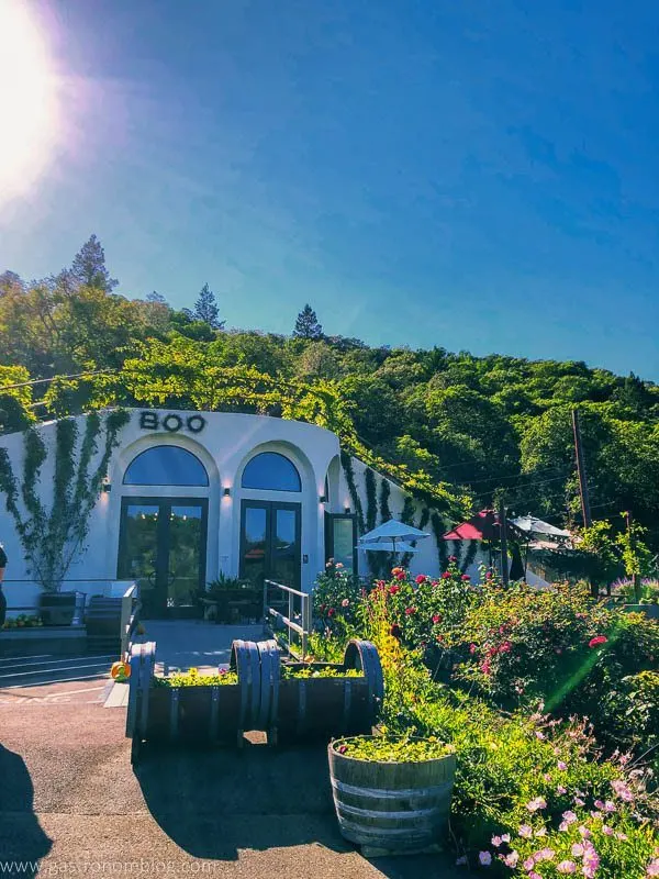 The tasting room of Fritz Underground Winery built into a hill is surrounded with flowers and a picnic area.