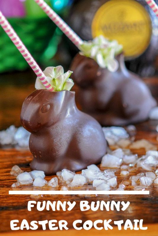 Hollow chocolate bunnies filled with crushed ice and a cocktail. Pink and white striped straw and flowers. 