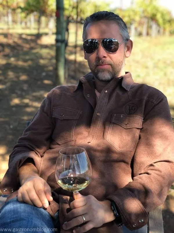Our friend, Brian chilling in the vineyard. wine glass in hand. 