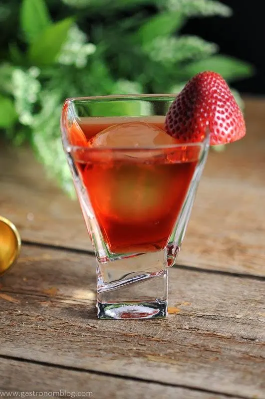 red drink in a glass with a strawberry