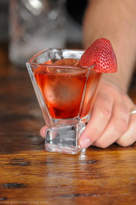 Pink cocktail in square glass with strawberry