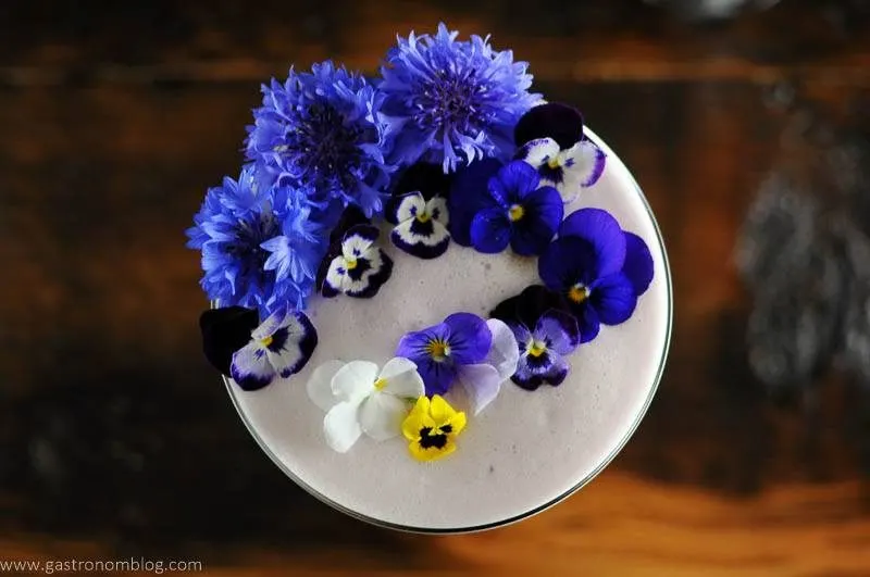 Edible flowers on top of egg white foam cocktail