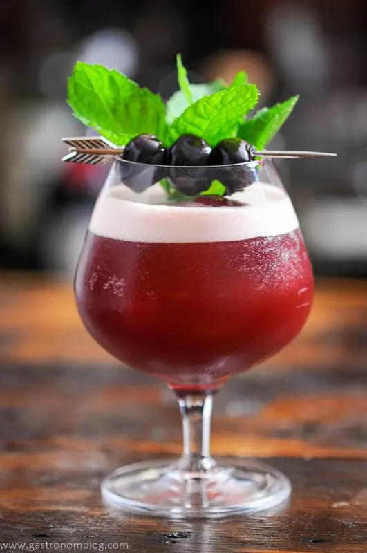 Cocktail in snifter, mint and cherry garnish