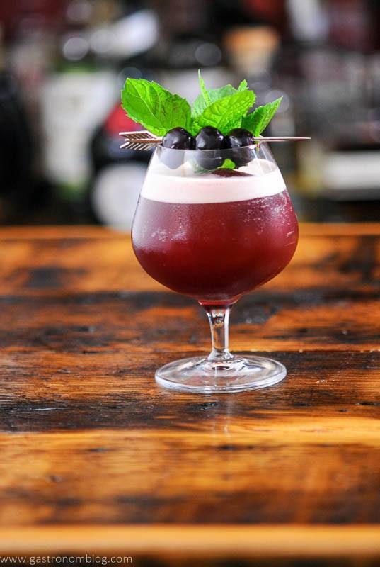 Cocktail with foam, cherries and mint