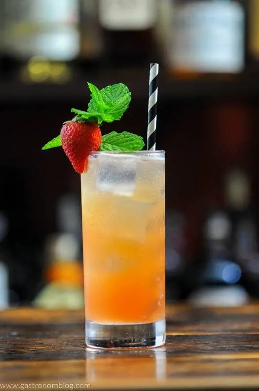 Strawberry Cocktail in highball with black and white straw