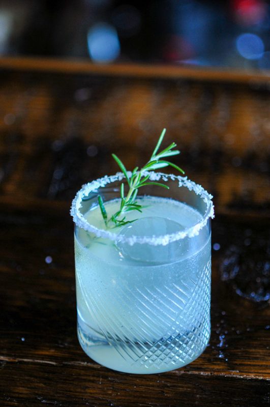 Cocktail with salt rim and rosemary sprig