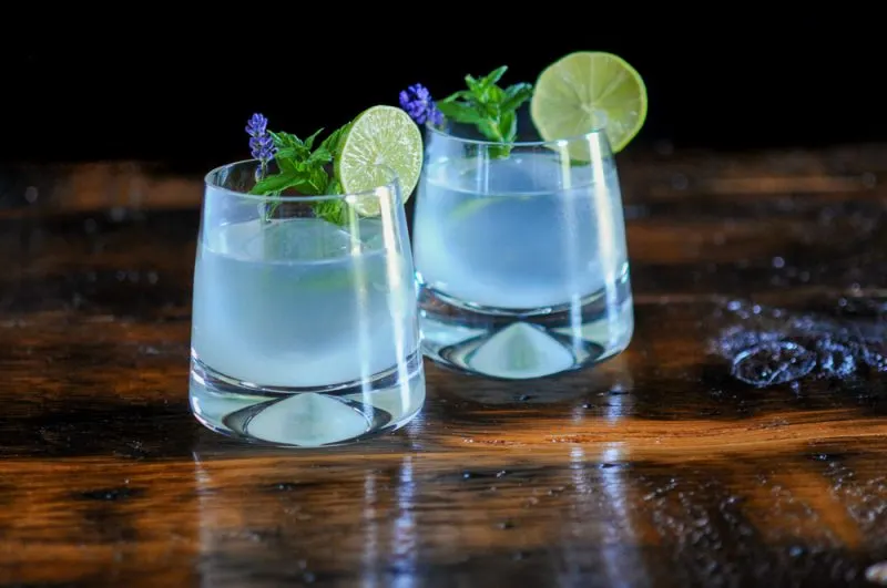 Cocktails with lime wheels, mint and lavender