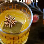 Whiskey cocktail in glass with star anise on top of ice, top shot