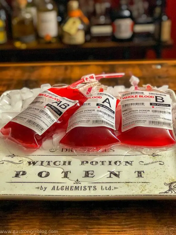 IV bags with red cocktail inside, on white plate