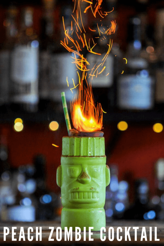 Green tiki cocktail with flames