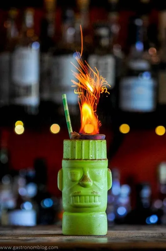 Rum cocktail in green mug with flames